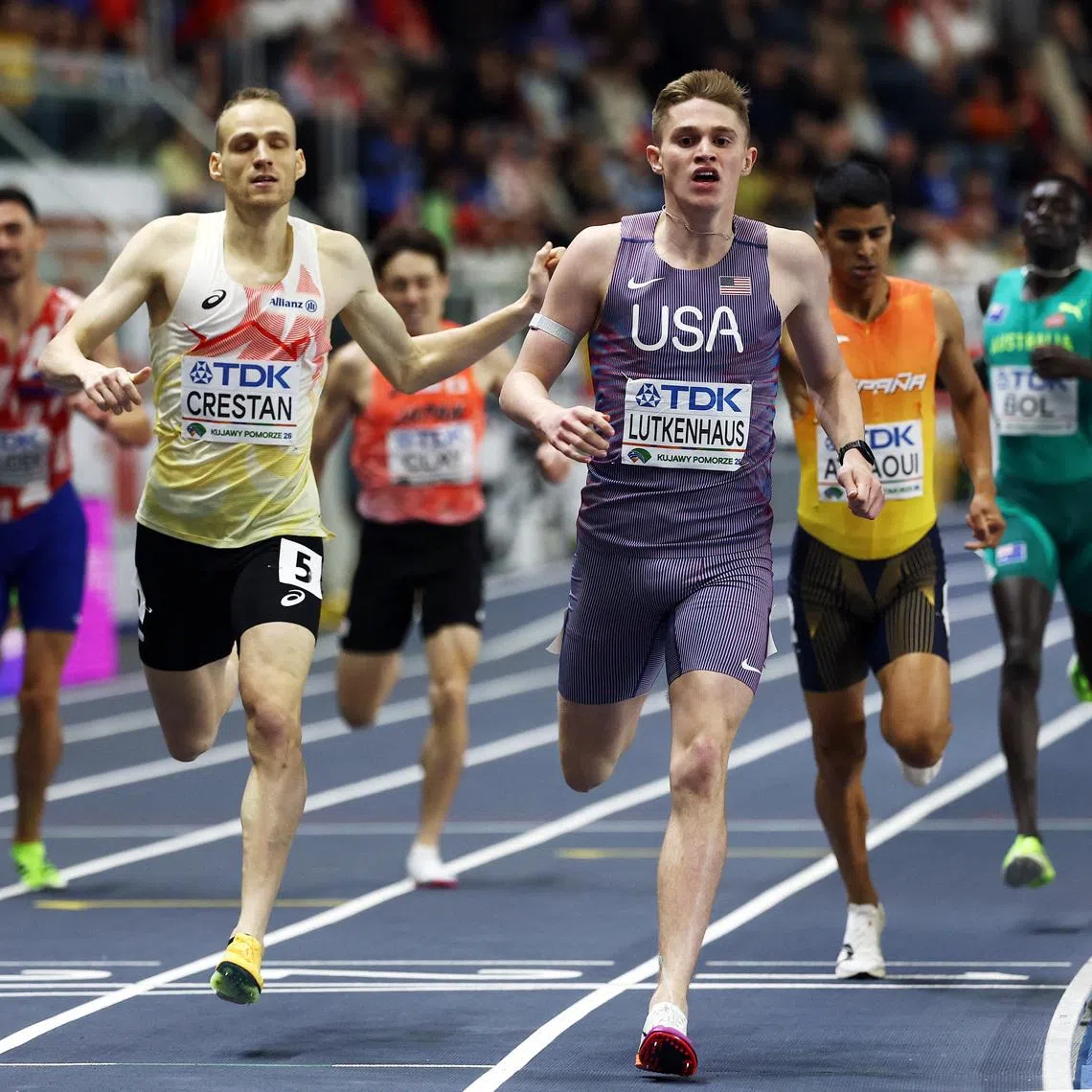 Athletics - World Indoor Championships - Kujawsko-Pomorska Arena, Torun, Poland - March 22, 2026 Cooper Lutkenhaus of the U.S. crosses the finish line to win gold in the men's 800m final as Belgium's Eliott Crestan crosses the finish line to win silver REUTERS/Kacper Pempel
