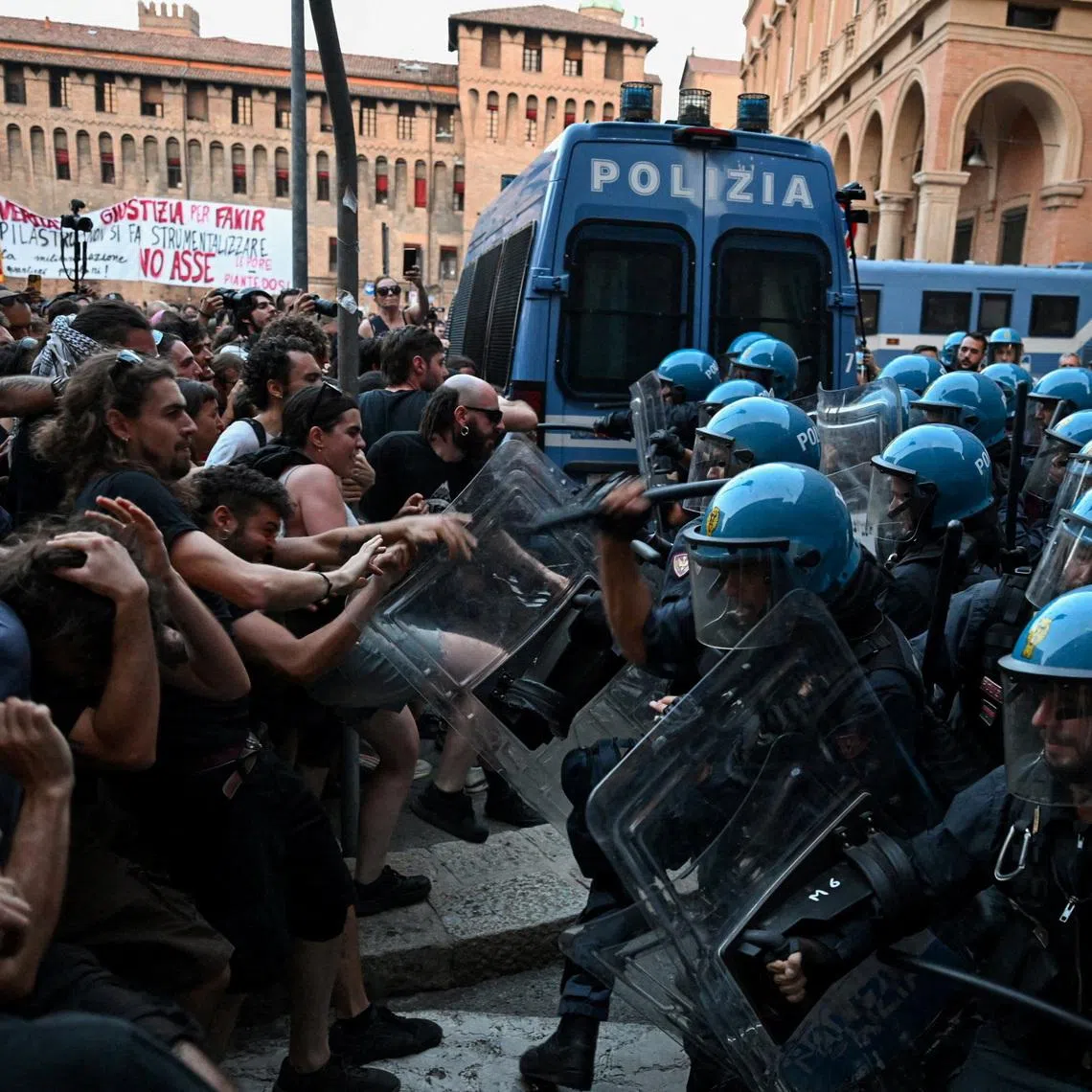 Protesters clash with riot police during a protest following the death of Abderrahim Fakir after he was restrained by police during an attempted detention, in Bologna, Italy, July 20, 2026. REUTERS/Michele Lapini