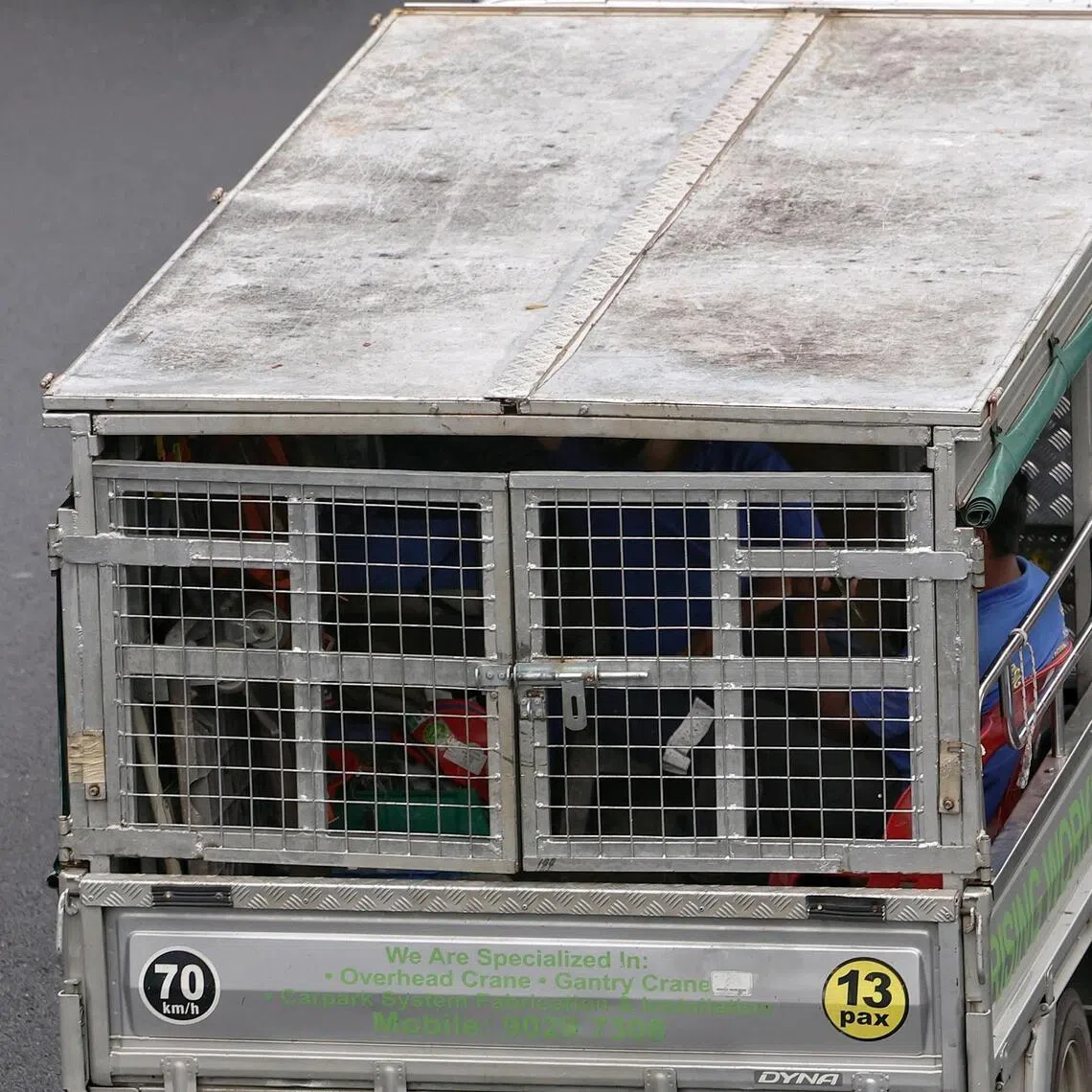 A worker sitting in a caged lorry on TPE on Feb 27, 2026. At the MOT COS budget debate, a ban on caged lorries will be announced.