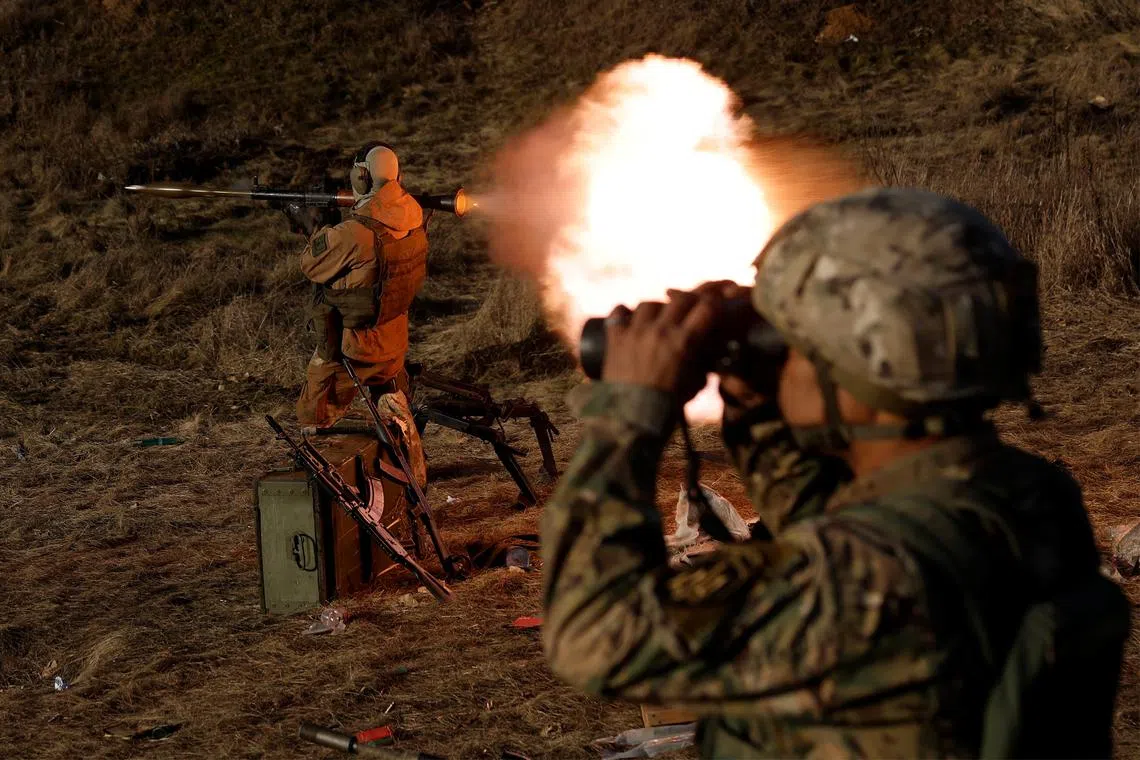 A soldier fires an RPG near the front line in Kreminna, Ukraine, on Jan 3, 2023.