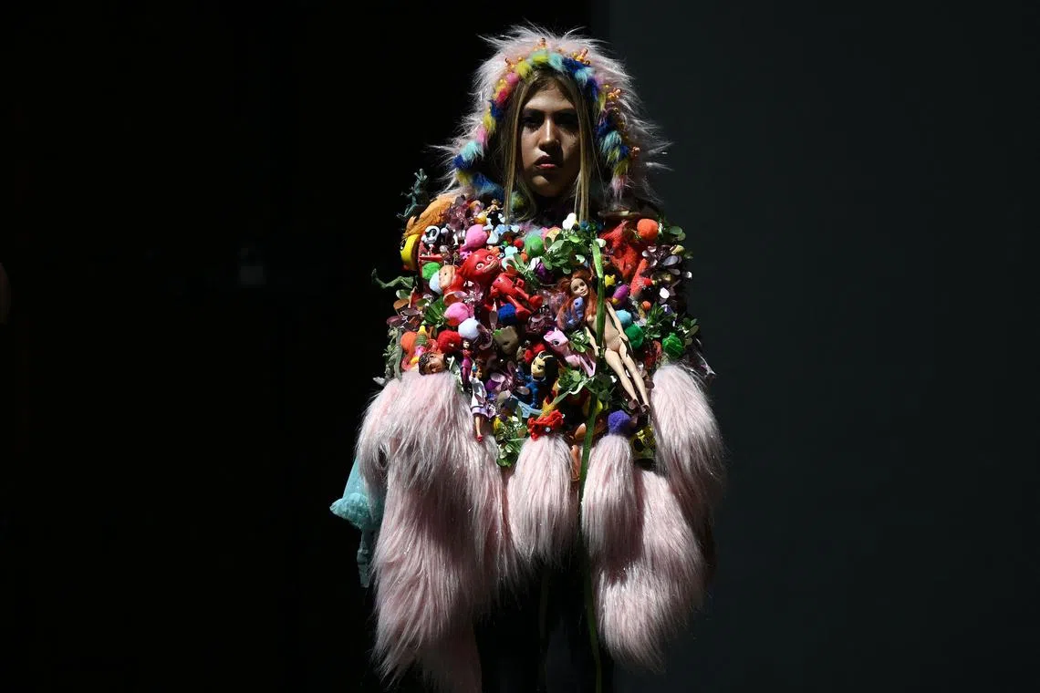 A model presenting a creation made with recycled material and usable waste during the "El Centro Vive Sostenible" fashion and sustainability event in Bogota, Colombia, on March 14, 2024.