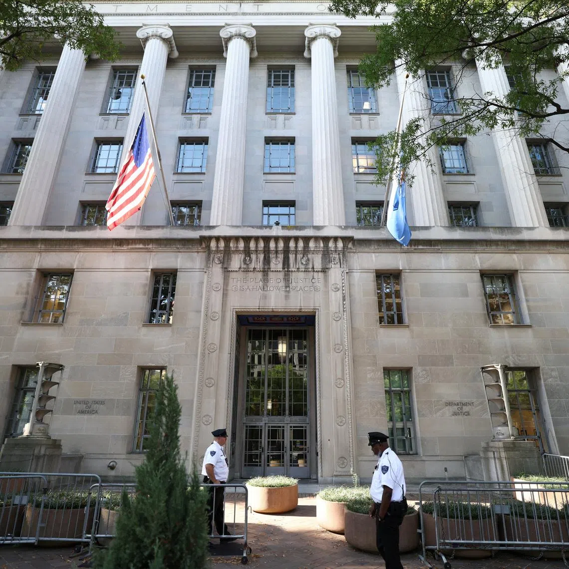 Officers keep watch outside the Department of Justice building in Washington, D.C., U.S., September 23, 2025. REUTERS/Kevin Lamarque