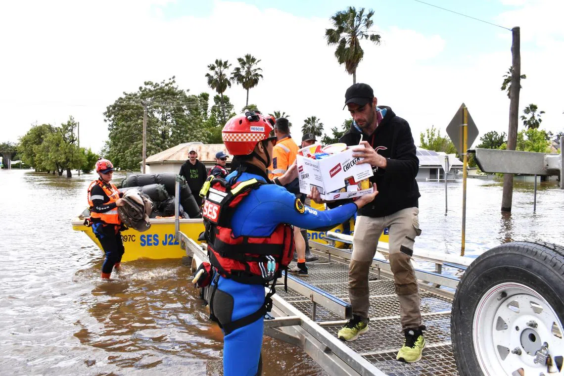 Residents and supplies are ferried through floodwater, in Central West New South Wales, Australia, Nov 16, 2022. 