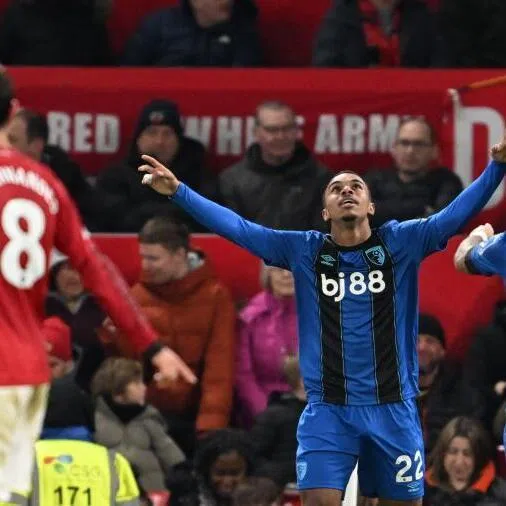 Bournemouth's French striker Eli Junior Kroupi (centre) celebrates scoring their fourth goal during the English Premier League football match against Manchester United.
