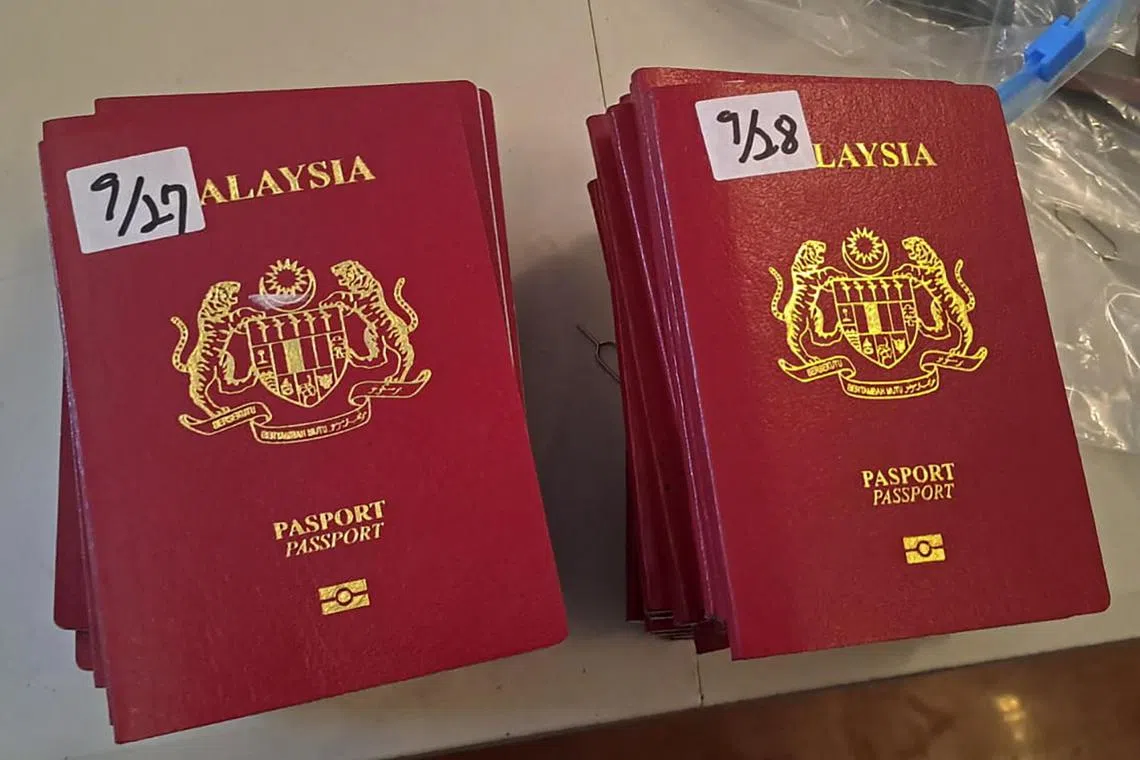 This handout picture released on Oct 9 by the Peruvian Ministry of Interior shows passports seized during the rescue of 44 Asian migrants during a police raid between Oct 7 and 8 in Lima. Peruvian police rescued 44 Asian migrants held captive by a  Taiwanese gang. 