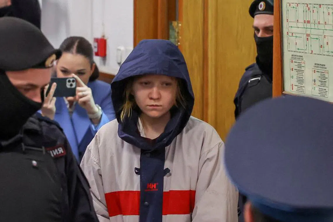FILE PHOTO: Darya Trepova, who is suspected in the killing of Russian military blogger Maxim Fomin, widely known by the name of Vladlen Tatarsky, is escorted inside a court building before a hearing in Moscow, Russia, April 4, 2023. REUTERS/Evgenia Novozhenina/File Photo