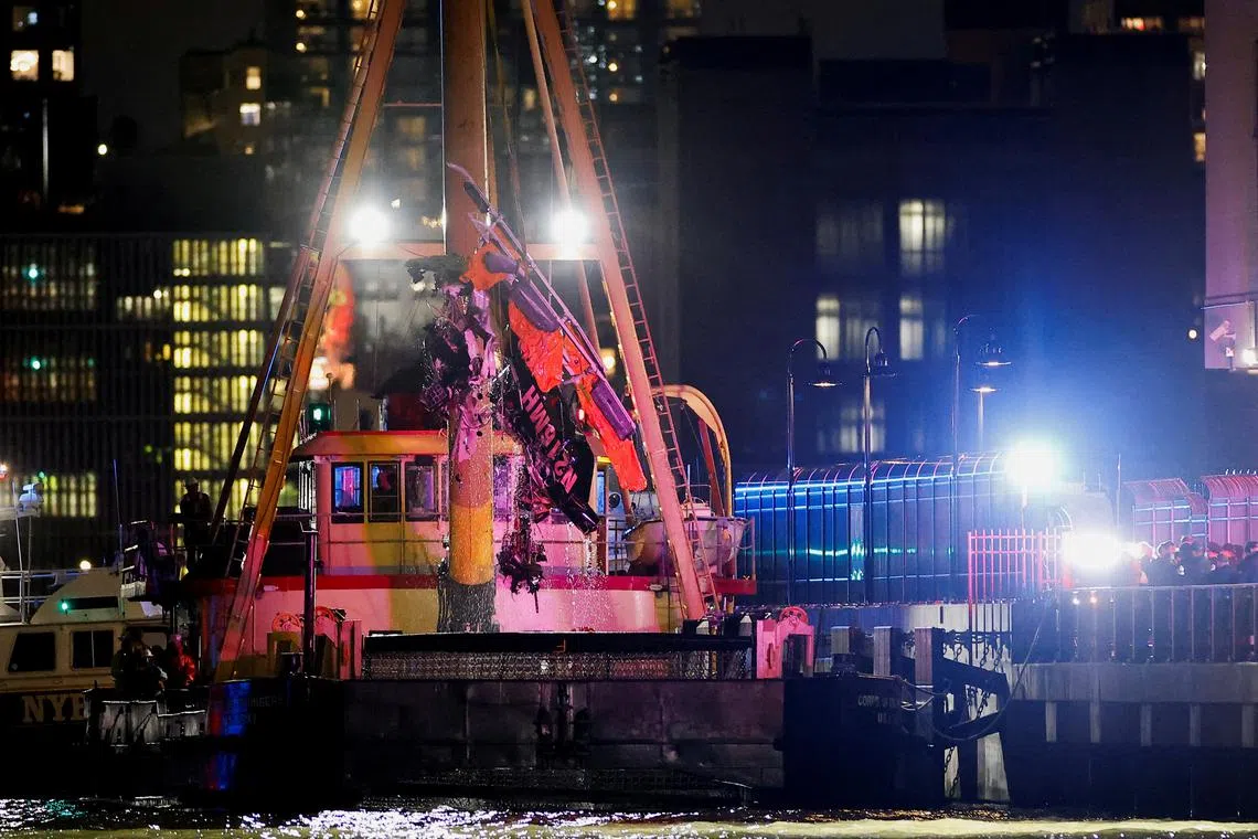 FILE PHOTO: Emergency personnel work at the scene of a helicopter crash on the Hudson River near lower Manhattan in New York, as seen from Newport, New Jersey U.S., April 10, 2025.  REUTERS/Eduardo Munoz/File Photo