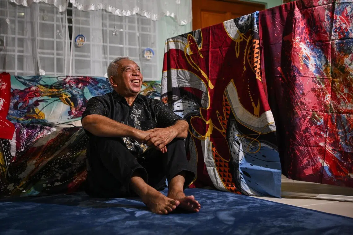 Ika Zahri Sarkasi with works by his father in his Yio Chu Kang home. 