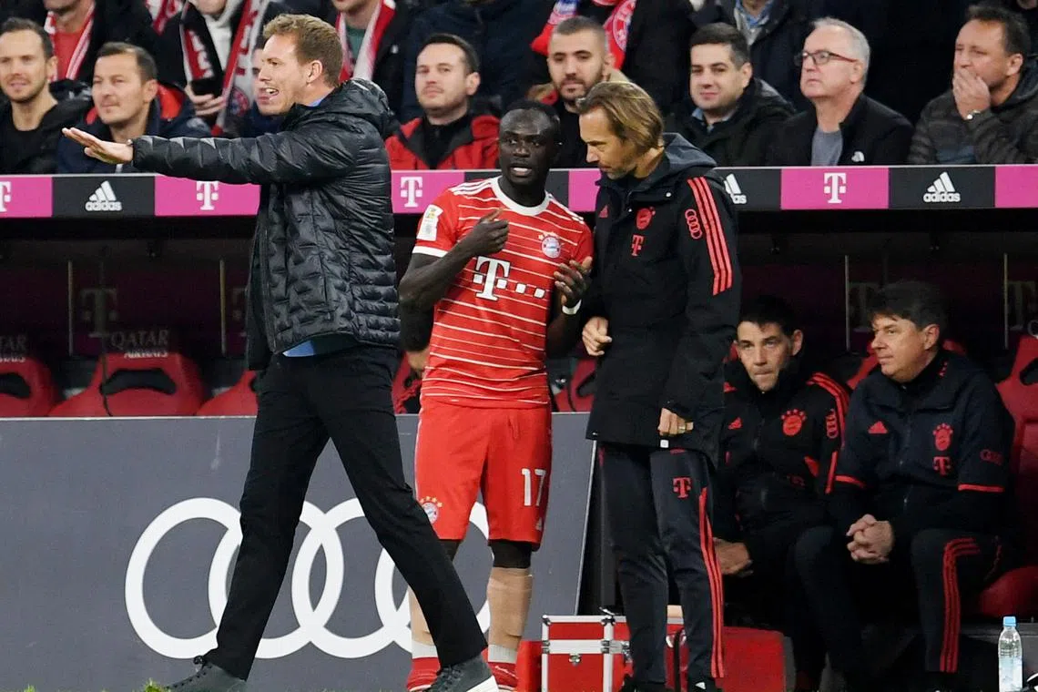 Bayern Munich's Sadio Mane after being substituted due to injury during the 6-1 win over Werder Bremen on Tuesday as coach Julian Nagelsmann looks on. Bayern assistant Dino Toppmoller later said the Senegalese's leg injury is “not too bad”.