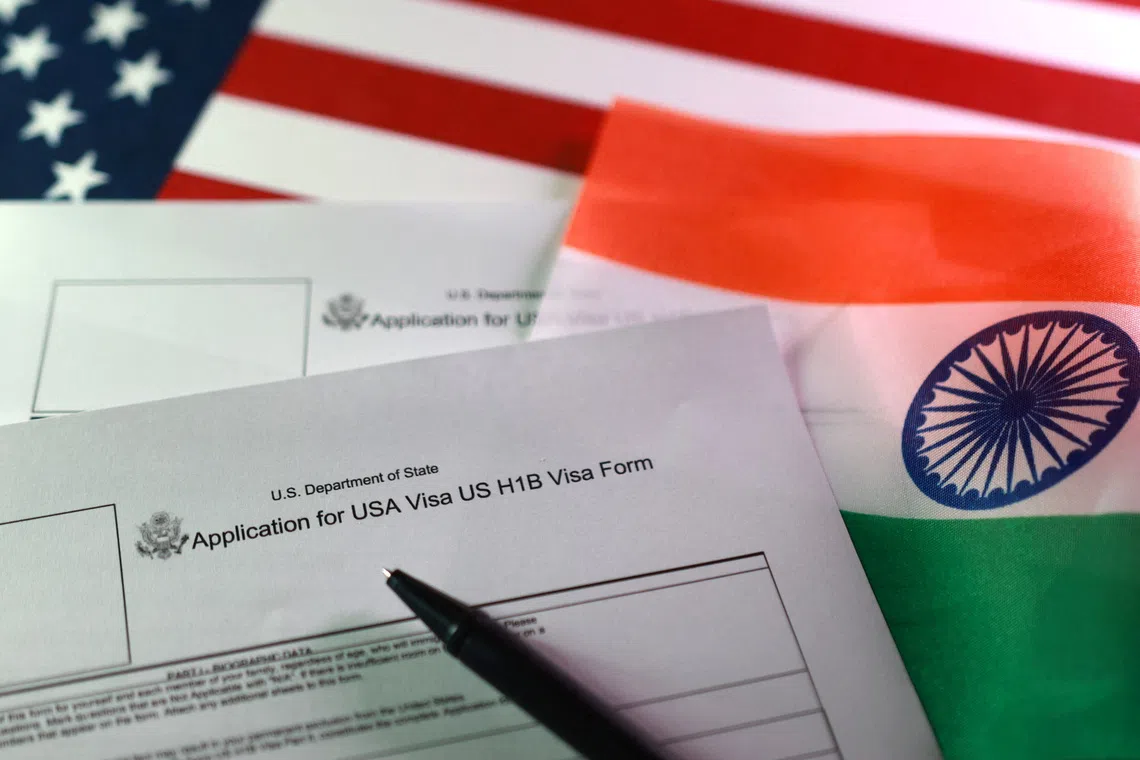 FILE PHOTO: U.S. and Indian flags and U.S. H-1B Visa application forms are seen in this illustration taken, September 22, 2025. REUTERS/Dado Ruvic/Illustration/ File Photo