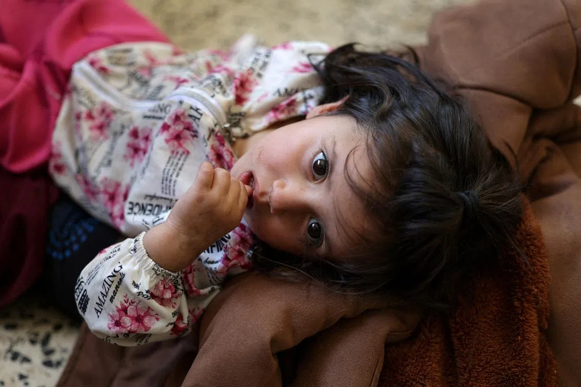 A child from a group of Bedouin families who left the town of Shahba, in a school that is used as a shelter centre, in the village of Nahtah in Deraa Governorate, Syria, on July 21, 2025. 