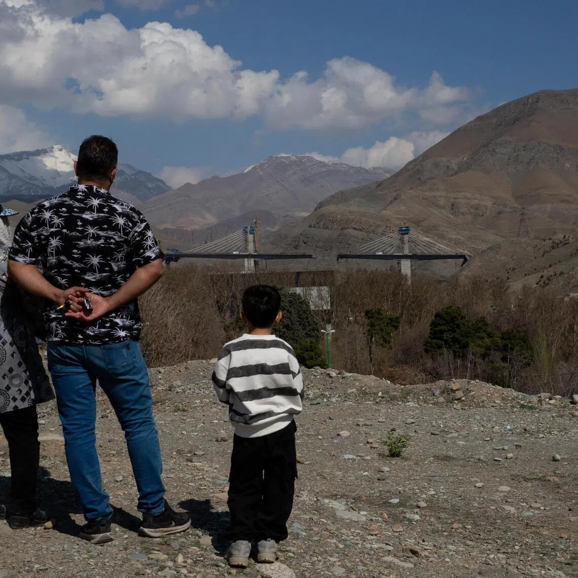 People look at a highway bridge near Tehran, Iran, that was damaged in a US strike that President Donald Trump celebrated on April 3, 2026.