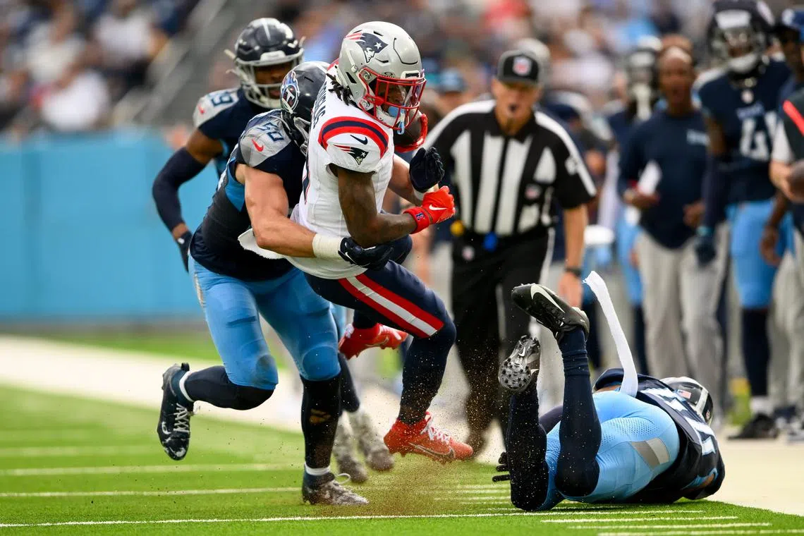 FILE PHOTO: Nov 3, 2024; Nashville, Tennessee, USA;  Tennessee Titans defensive back Julius Wood (24) and linebacker Jack Gibbens (50) tackle New England Patriots wide receiver DeMario Douglas (3) during the first half at Nissan Stadium. Steve Roberts-Imagn Images/File Photo