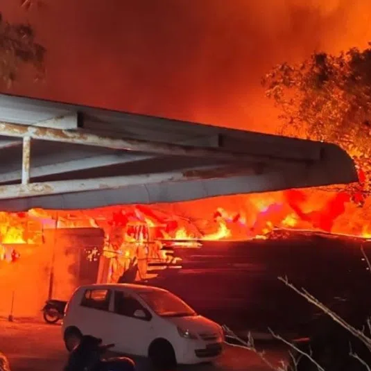 A recycling centre was engulfed in the fire, with explosions heard repeatedly as flames spread to a nearby automobile service centre.
