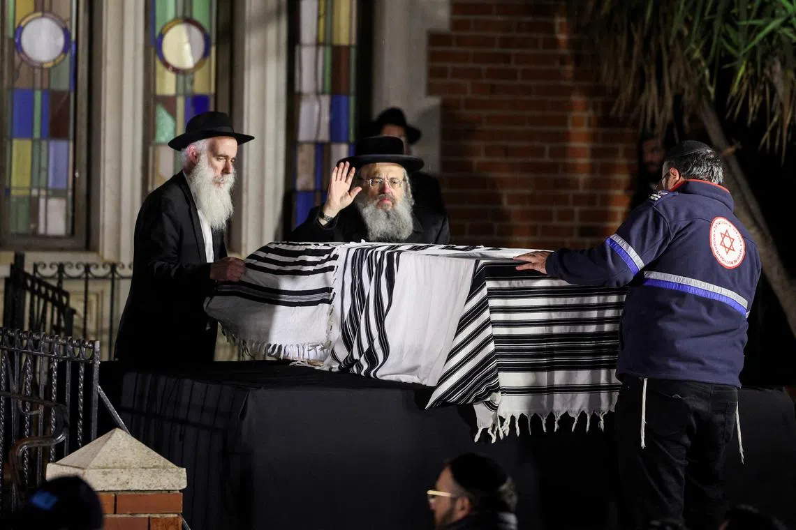 FILE PHOTO: People stand next to the coffin of Israeli rabbi, Zvi Kogan, who was found murdered in the United Arab Emirates, during his funeral, in Kfar Habad, Israel, November 25, 2024. REUTERS/Stoyan Nenov/File Photo