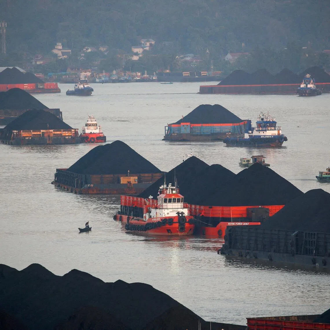Coal barges queue to be pulled along Mahakam river in Samarinda, East Kalimantan province, Indonesia, on Aug 31, 2019.