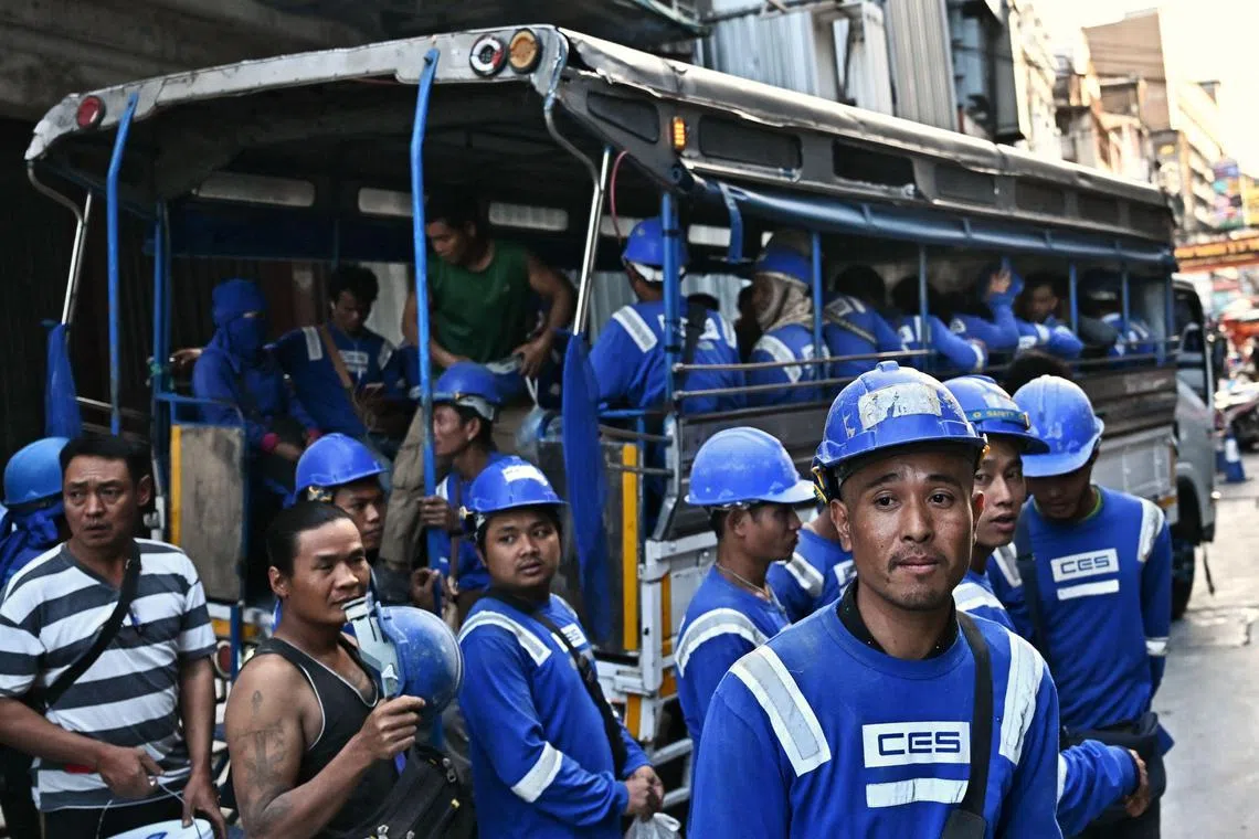 Construction workers leave their work site in Bangkok's Chinatown.