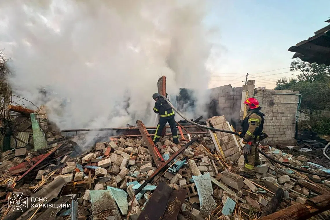 Firefighters working at the site of a private house destroyed overnight in Russian drone strikes, in the town of Balakliia, in Ukraine’s Kharkiv region, on Aug 6.