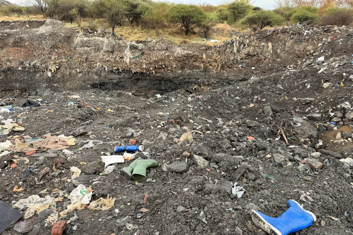 Rubber boots believed to belong to illegal miners lay near a shaft entrance at a disused mine near Rustenburg, North West province, South Africa, August 11, 2026. South African police said on Tuesday that 14 illegal miners had died and scores of others were injured at the mine. REUTERS/Siyabonga Sishi