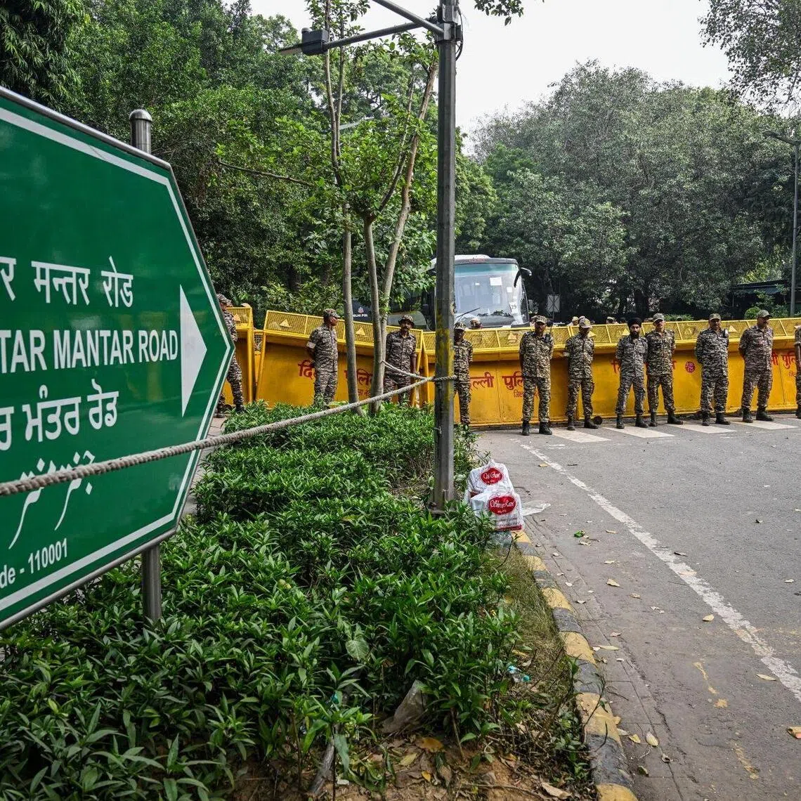 Police officers and paramilitary personnel stand guard outside Jantar Mantar ahead of a youth-led demonstration in New Delhi.