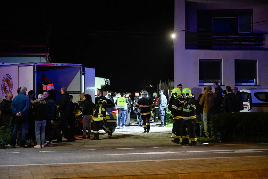 First responders attend the scene of a collision between two trains in the town of Pezinok, Slovakia.