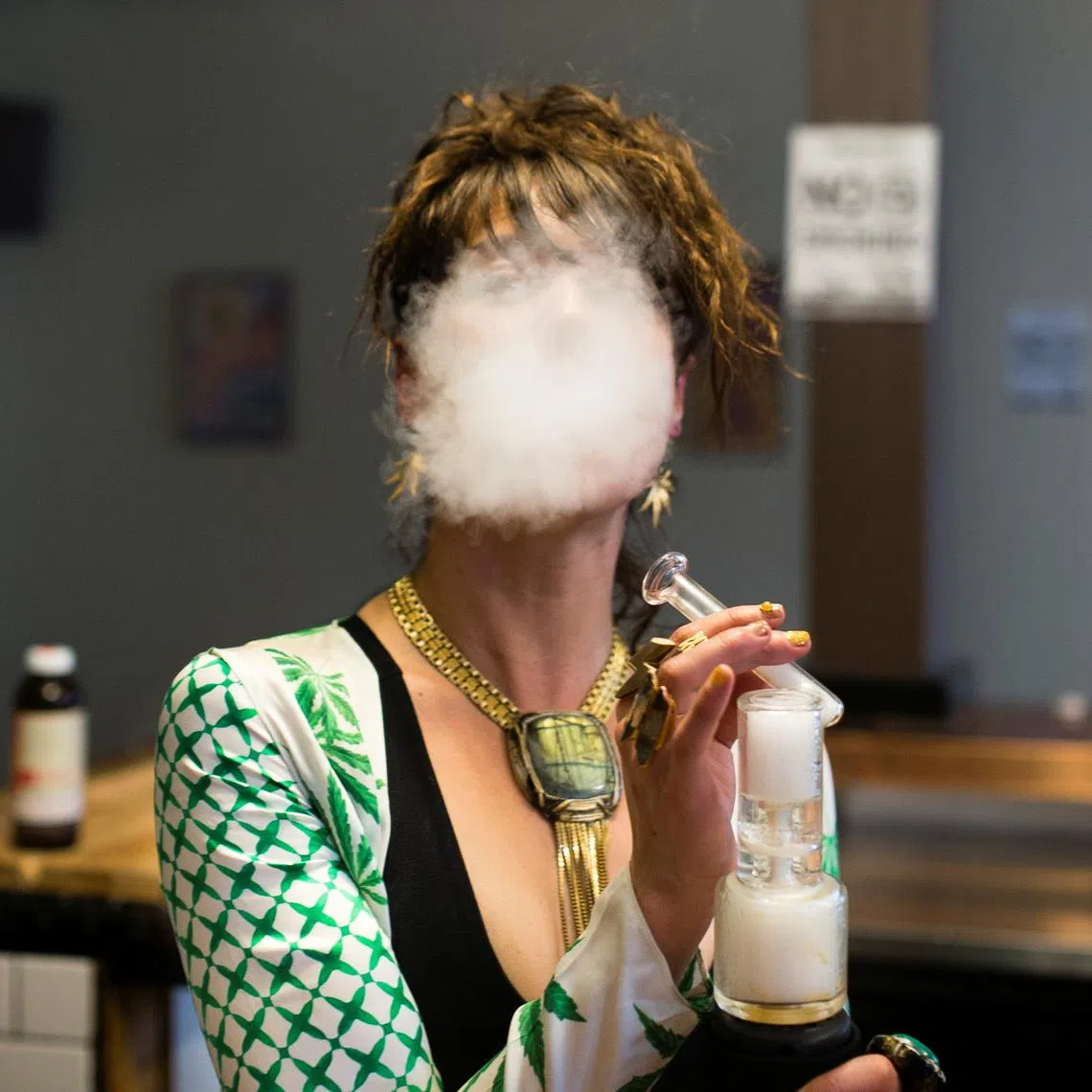FILE PHOTO: A woman uses a full spectrum oil vaporizer at the Magnolia cannabis vape lounge in Oakland, California, U.S. April 20, 2018. . REUTERS/Elijah Nouvelage/File Photo