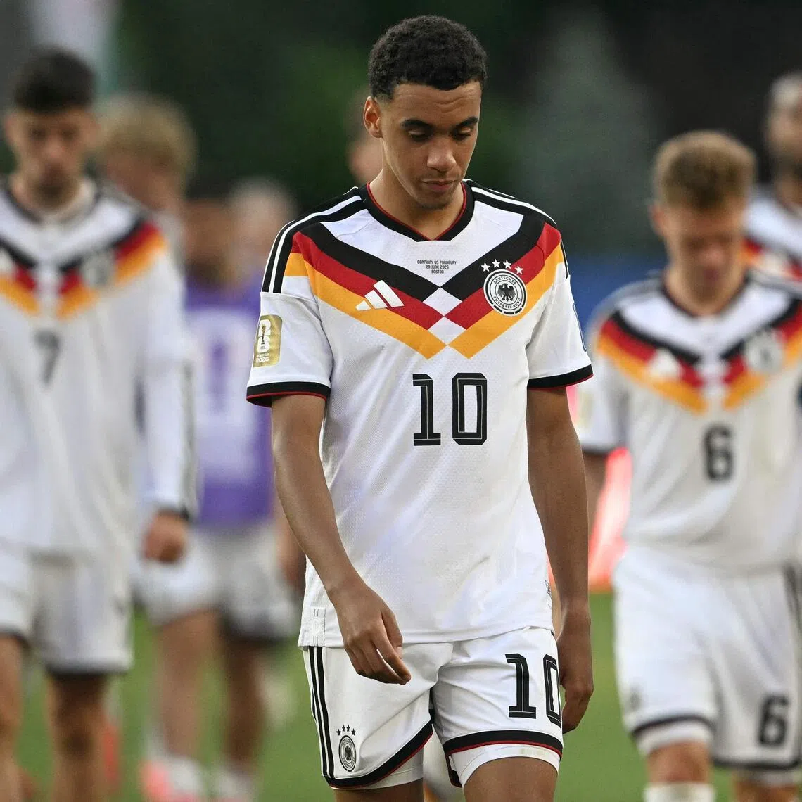 TOPSHOT - Germany's midfielder #10 Jamal Musiala reacts after losing the penalty shootout during the 2026 World Cup round of 32 football match between Germany and Paraguay at the Boston Stadium in Foxborough on June 29, 2026.  (Photo by MAURO PIMENTEL / AFP)