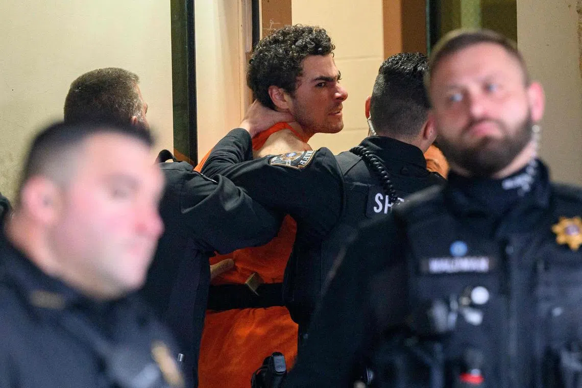 TOPSHOT - HOLLIDAYSBURG, PENNSYLVANIA - DECEMBER 10: Luigi Mangione is led into the Blair County Courthouse for an extradition hearing December 10, 2024 in Hollidaysburg, Pennsylvania. Mangione has been arraigned on weapons and false identification charges related to the fatal shooting of United Healthcare CEO Brian Thompson in New York City. Mangione is incarcerated in the State Correctional Institution in Huntingdon, Pennsylvania awaiting extradition to New York.   Jeff Swensen/Getty Images/AFP (Photo by JEFF SWENSEN / GETTY IMAGES NORTH AMERICA / Getty Images via AFP)