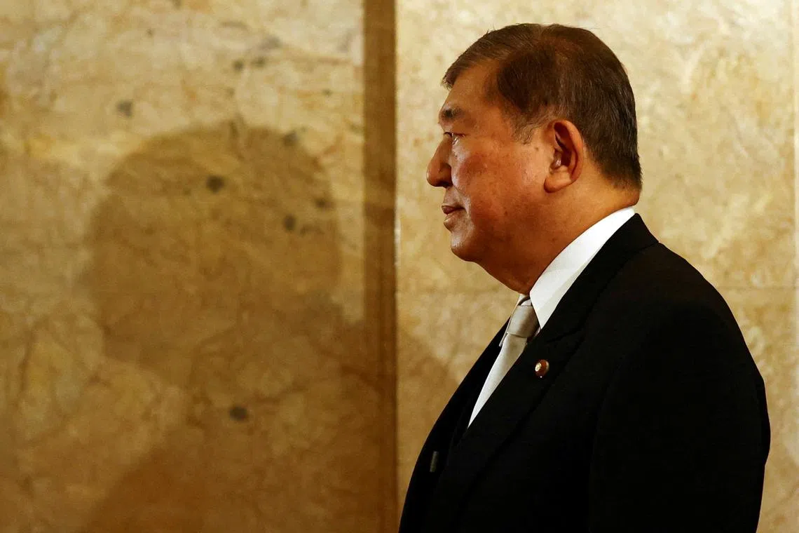FILE PHOTO: Japan's Prime Minister Shigeru Ishiba, wearing a formal attire, walks toward the upper house hall to attend an opening ceremony of the parliamentary session in Tokyo, Japan August 1, 2025.  REUTERS/Issei Kato/File Photo