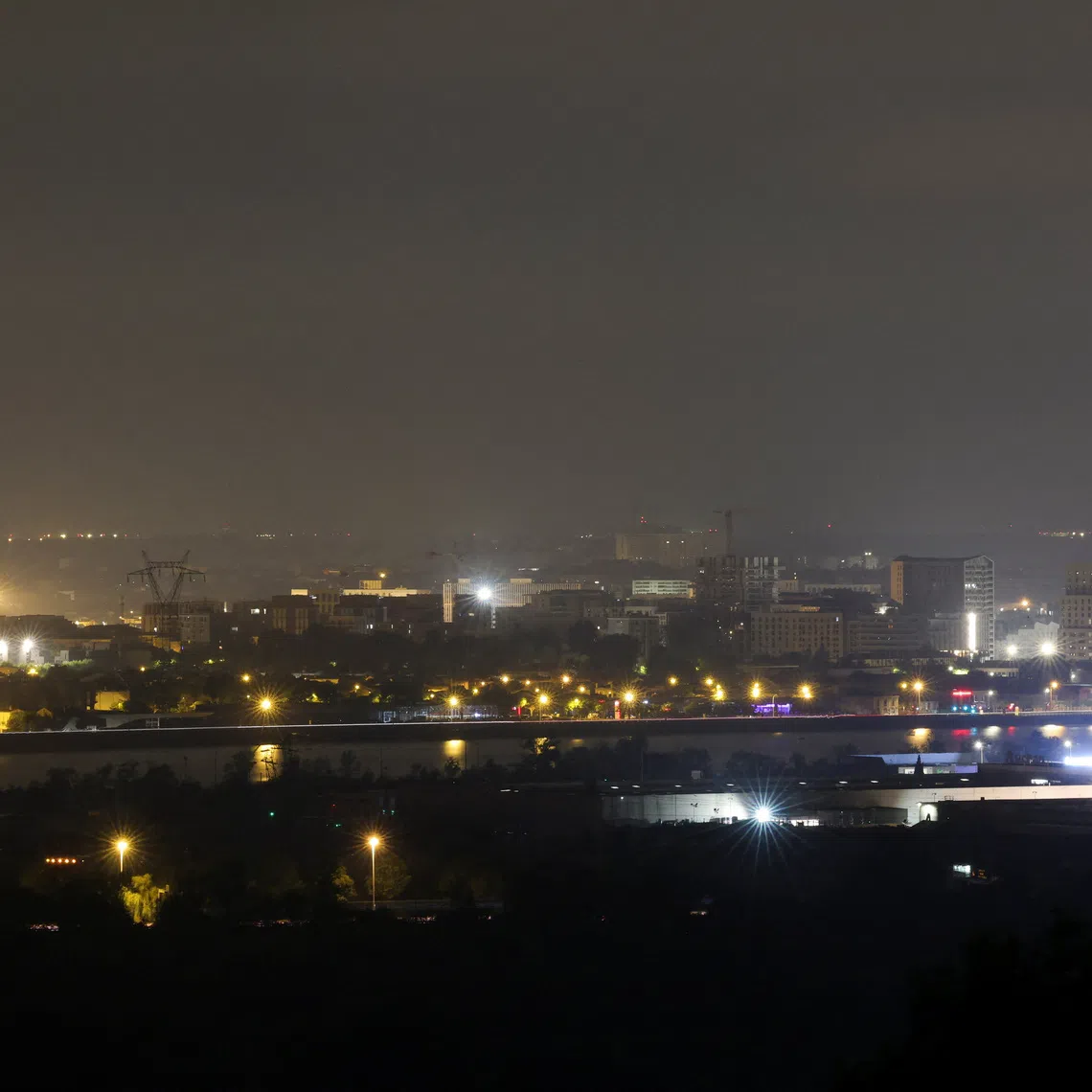 A view of the city of Bordeaux from Bouliac, as a wildfire burns nearby amid worsening drought conditions following a heatwave and water shortages across much of France, July 25, 2026. REUTERS/Stephane Mahe