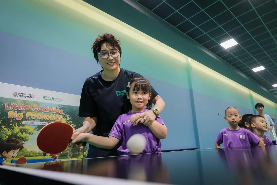 Former national table tennis player Feng Tianwei interacts with New Life pre-school children during the launch of “Little Paddles, Big Potential”, a two-year partnership between Preschool Market and Feng Tianwei International Table Tennis Academy (FTTA), at The Sports Arina @ Jalan Kayu on Oct 21, 2026. The initiative aims to introduce young children to structured sports experiences and help them discover their interests and potential.