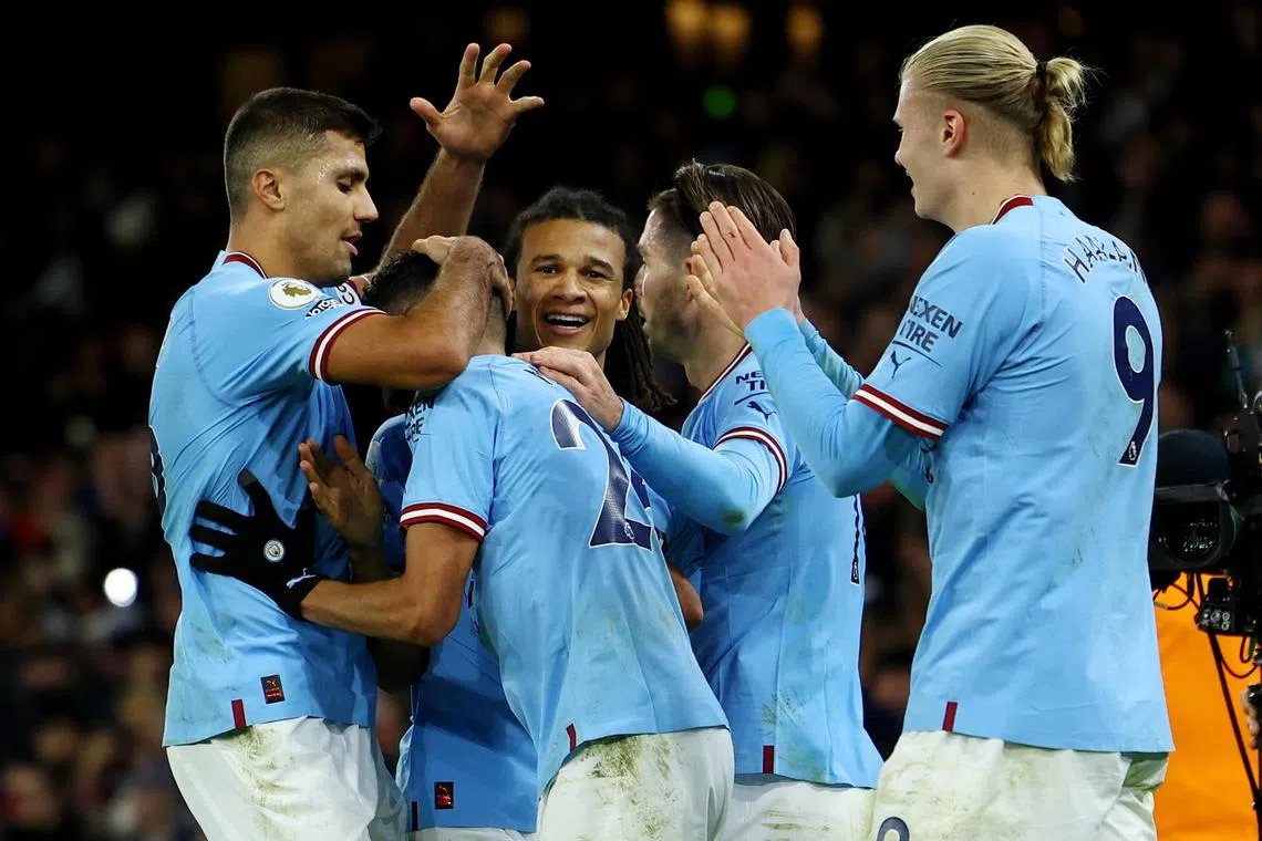 Riyad Mahrez celebrates scoring City's fourth goal, and his second, with teammates.