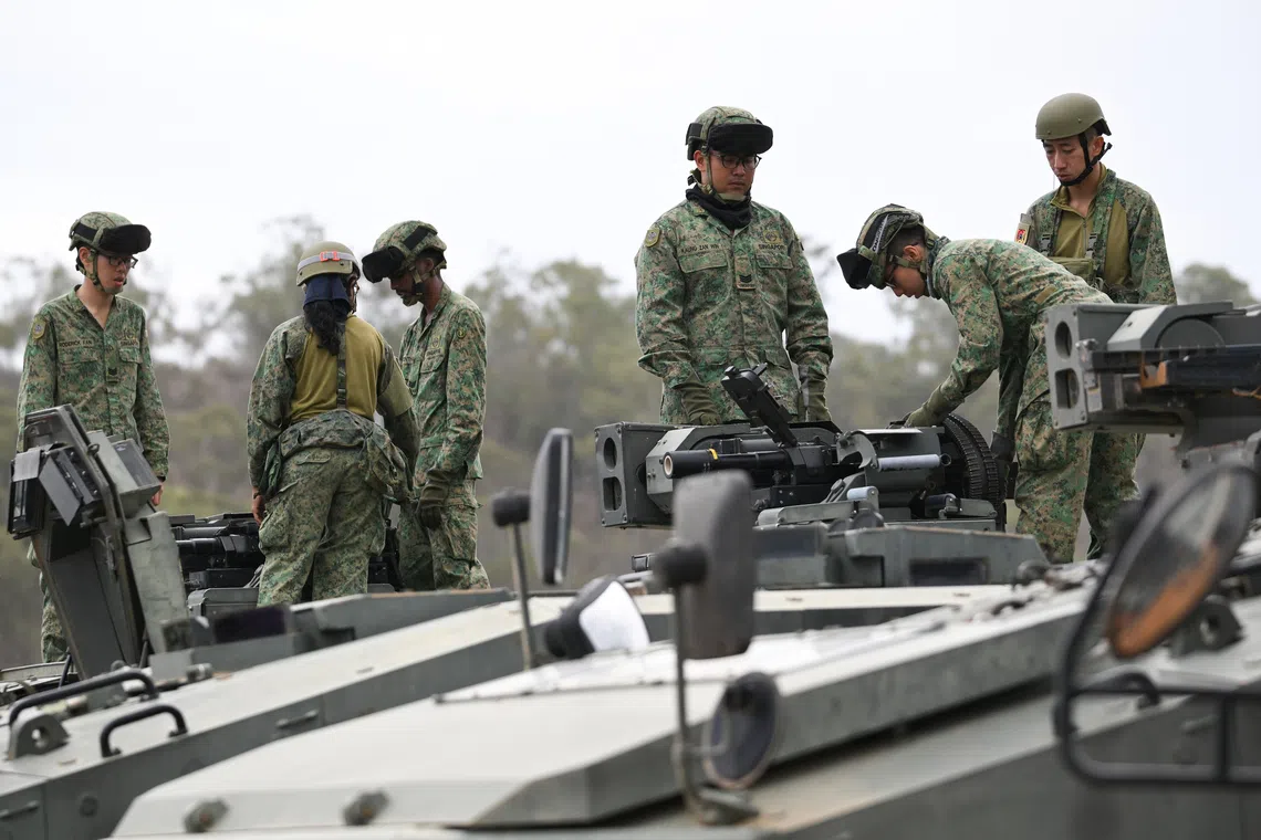 5 SIR personnel doing weapon checks on the Terrex Infantry Carrier Vehicles at Camp Tilpal in the Shoalwater Bay Training Area in Queensland, Australia on Oct 22.