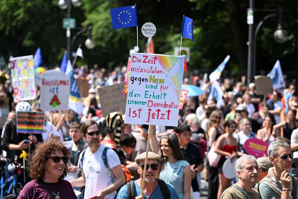 A banner reads "The time to stand up against hate and to preserve our democracy is now", at an anti-far right rally in Berlin, on June 8.