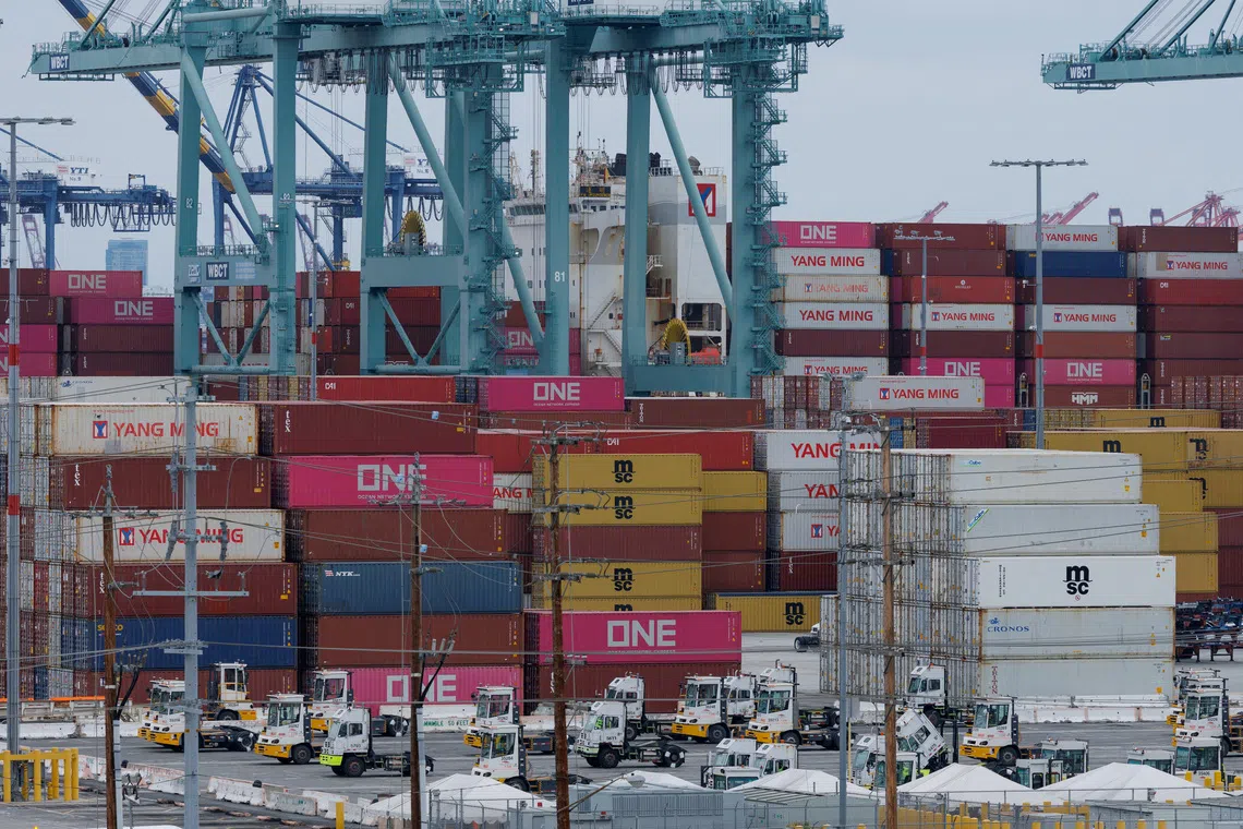 FILE PHOTO: A container ship is unloaded at the Port of Los Angeles, in San Pedro, California, U.S., May 1, 2025. REUTERS/Mike Blake/File Photo