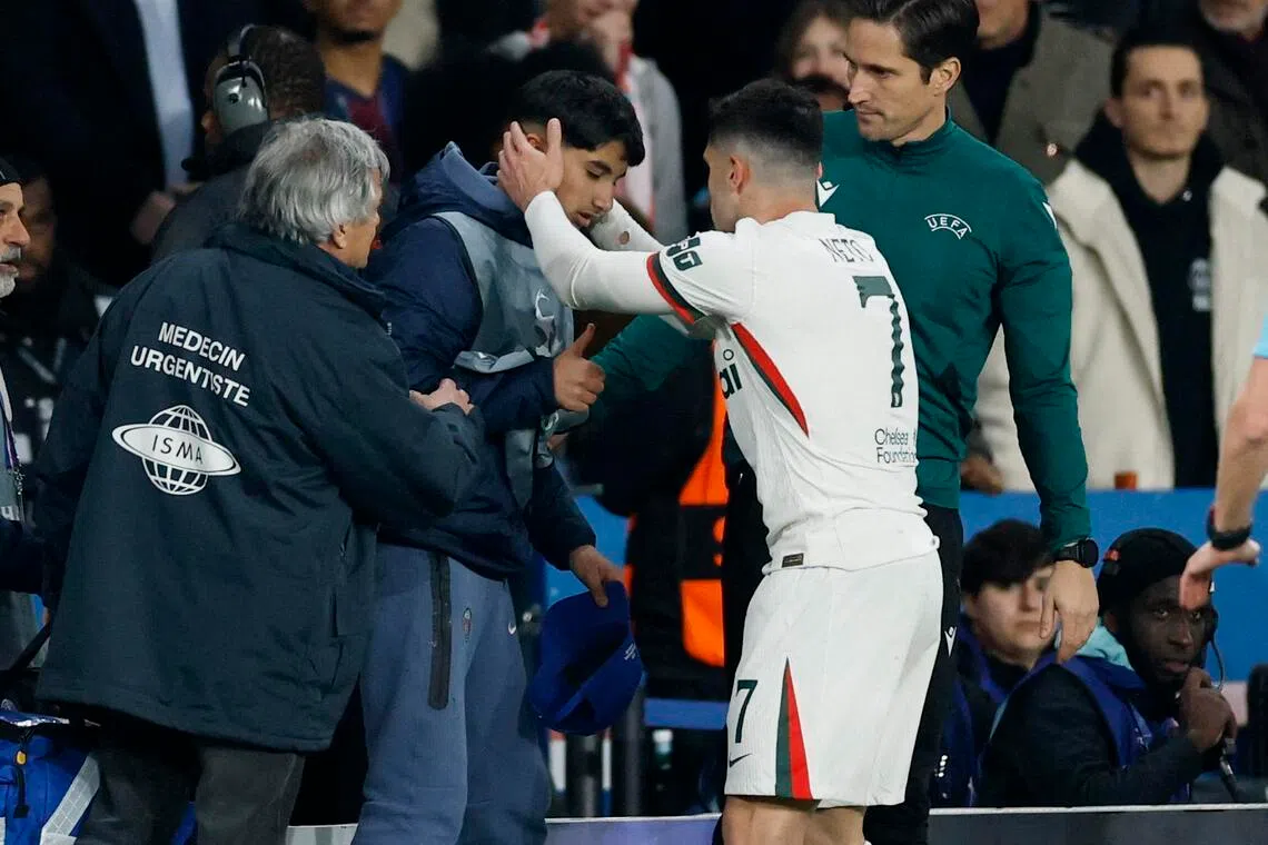 Pedro Neto checking on ball boy after pushing him during Chelsea's Champions League match against Paris Saint-Germain. Neto is facing disciplinary action over the incident for unsporting behaviour. 