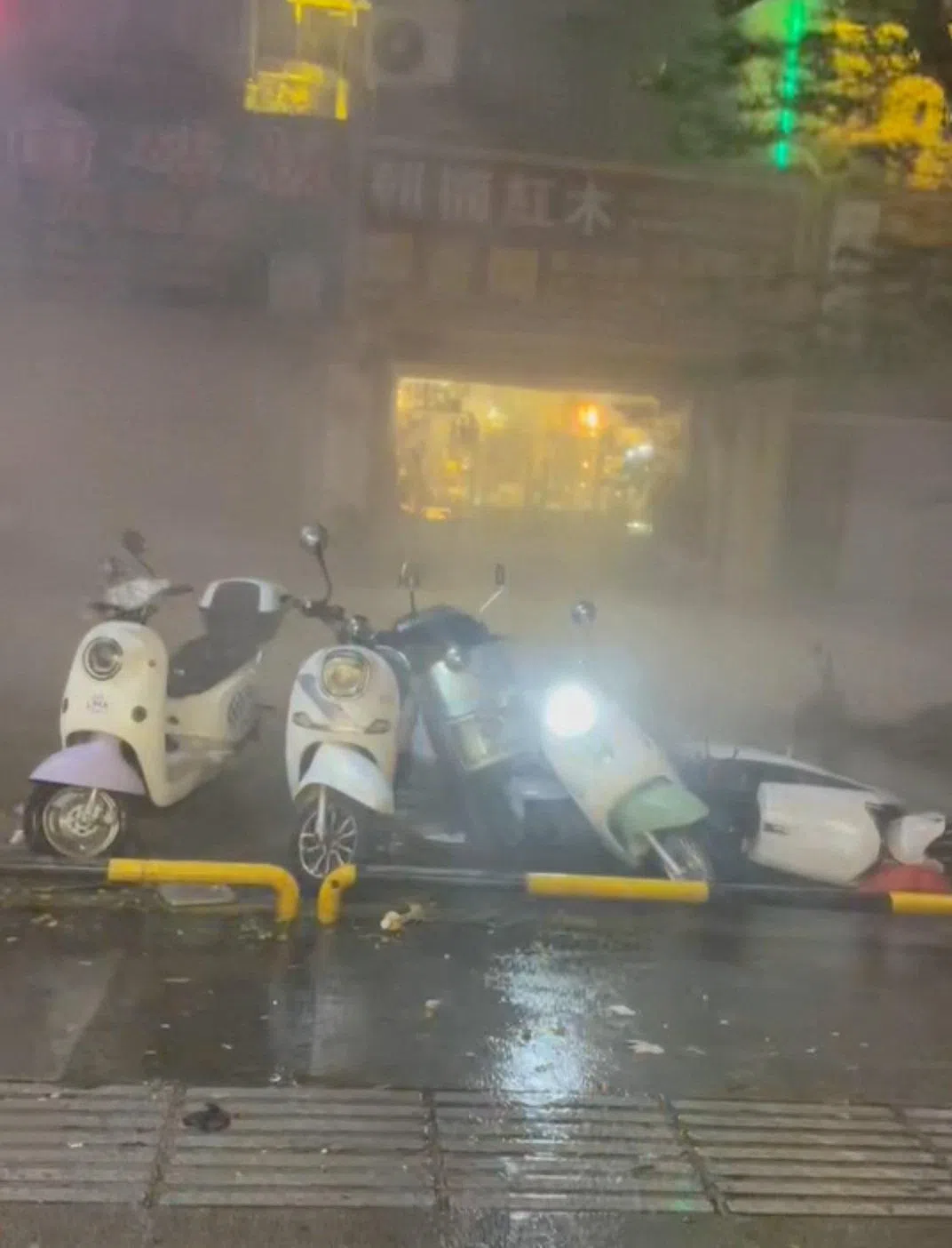 Scooters toppling over due to heavy rainfall following Typhoon Maysak, in Fangchenggang, in China’s Guangxi region, on July 4.
