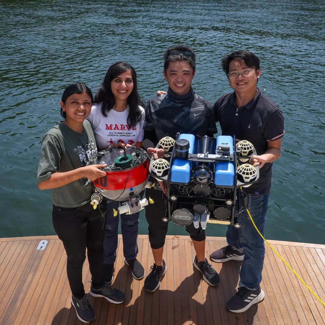 Dr Malika Meghjani (second from left) with her team members (from left) research assistant Shrutika Vishal Thengane, hardware engineer Hoo Jun Jie, and Master’s student Marcel Bartholomeus Prasetyo and their underwater robot on Sep 25.