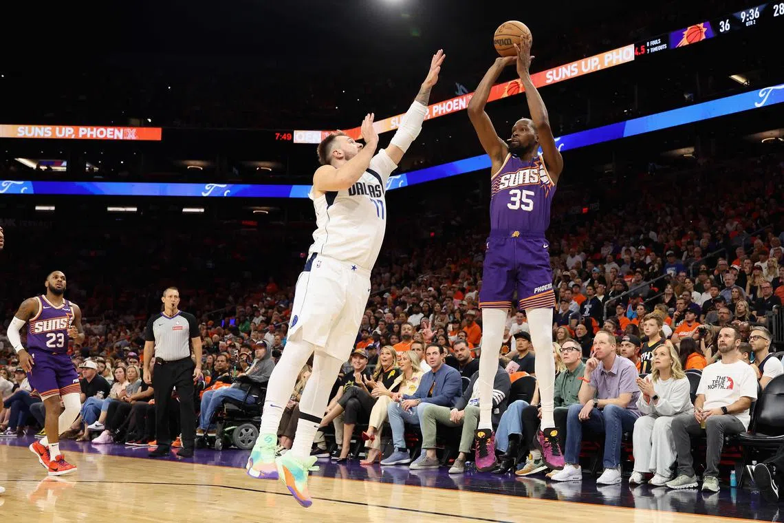 Kevin Durant of the Phoenix Suns putting up a three-point shot over Luka Doncic of the Dallas Mavericks during the first half of the NBA game at Footprint Centre on Oct 26. The Suns won 114-102.