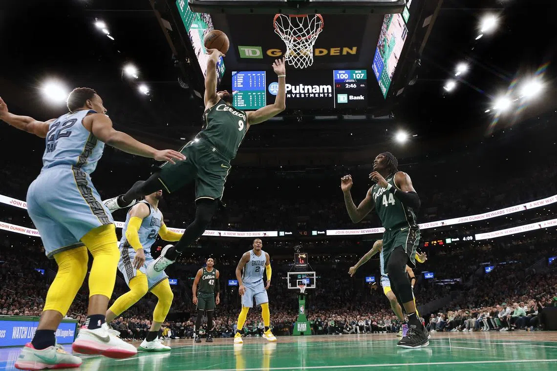 Boston Celtics' Derrick White (9) goes to the basket against the Memphis Grizzlies during the second half of the match.