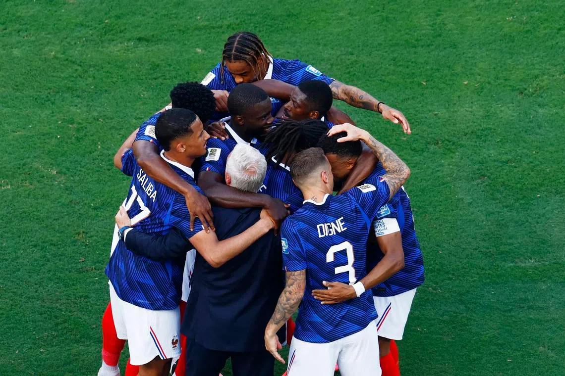 France celebrate their first goal with coach Didier Deschamps.