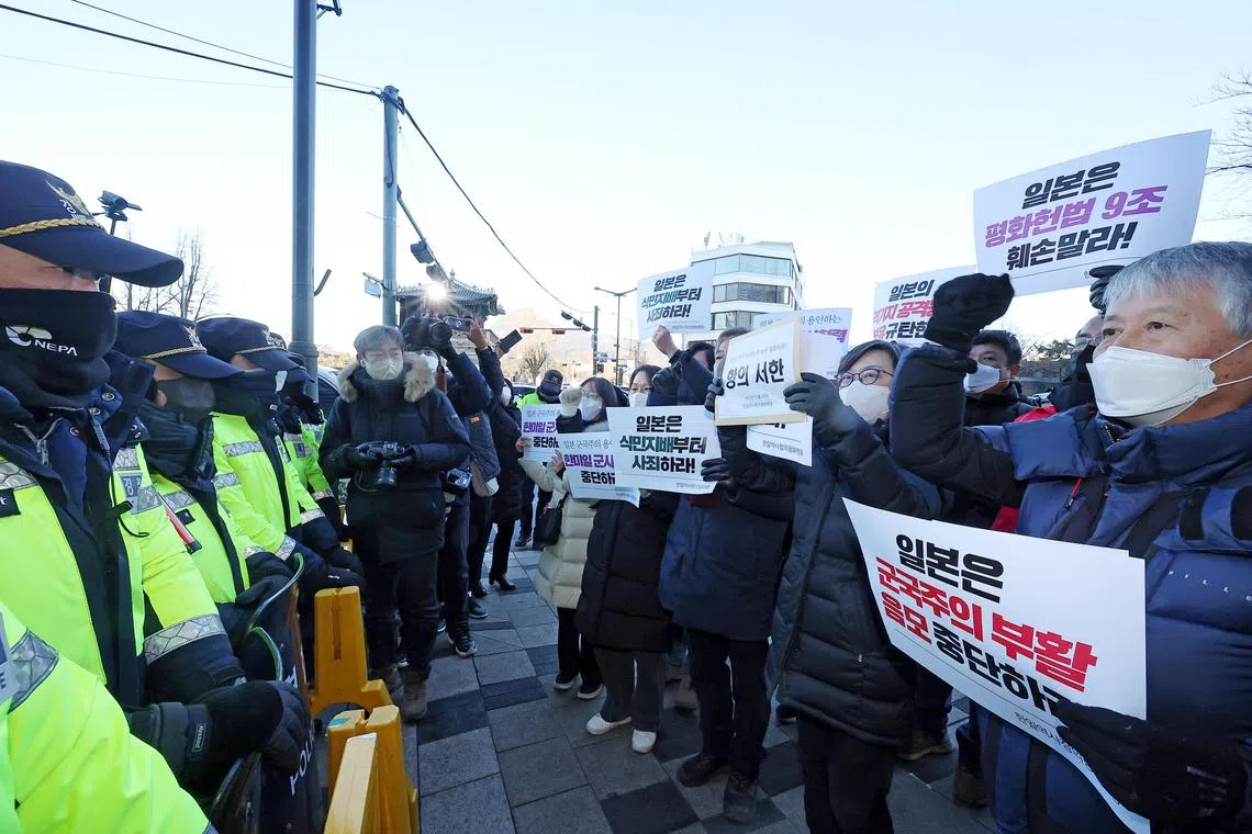Protesters confront police officers in front of the Japanese Embassy, to protest Japan's decision to acquire the capability to strike enemy bases, in Seoul on Dec 20, 2022. 