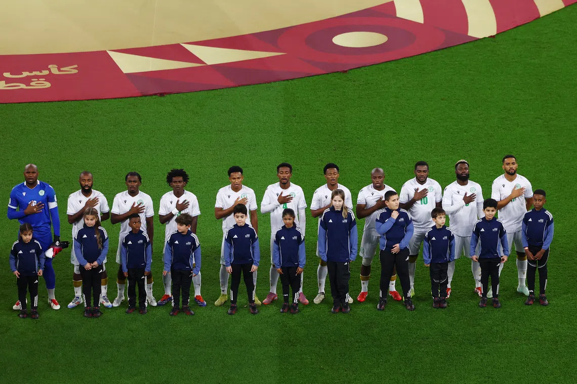 Soccer Football - FIFA Arab Cup - Qatar 2025 - Group B - Oman v Comoros - Stadium 974, Doha, Qatar - December 8, 2025 Comoros players line up with young mascots during the national anthems before the match REUTERS/Rula Rouhana