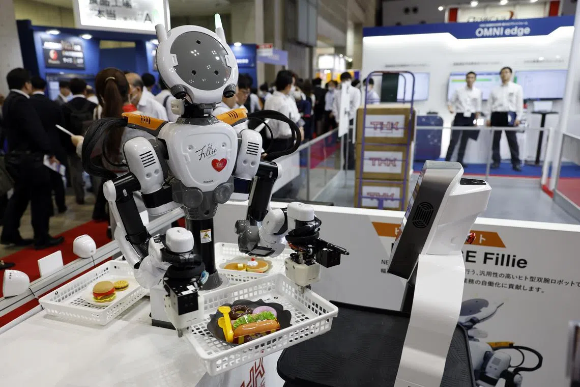 The robot Nextage Fillie performs a demonstration during the FOOMA Japan exhibition in Tokyo, on June 5.