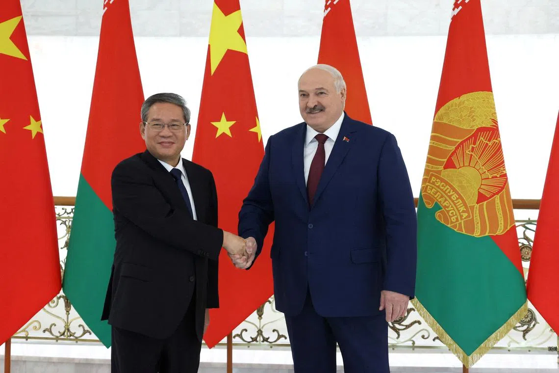 Belarusian President Alexander Lukashenko shakes hands with China's Premier Li Qiang during a meeting in Minsk, Belarus August 22, 2024. Press Service of the President of the Republic of Belarus/Handout via REUTERS