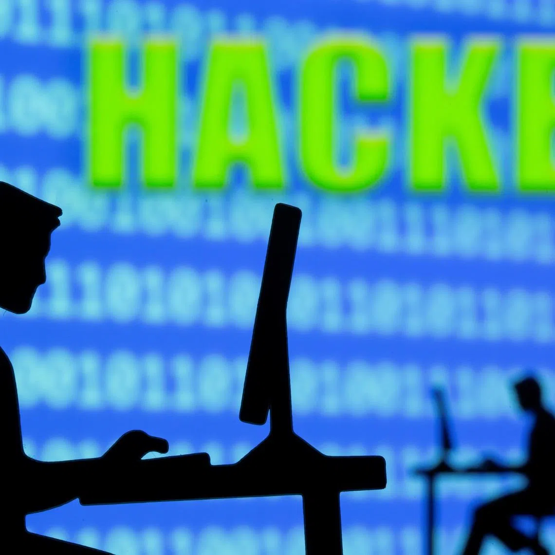 A 3D printed model of men working on computers are seen in front of displayed binary code and words \"Hacker\" in this illustration taken, July 5, 2021. REUTERS/Dado Ruvic/Illustration