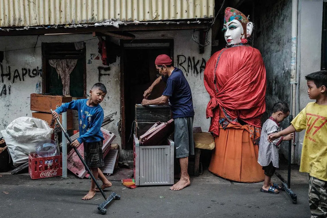 An ondel-ondel puppet is seen in an alley in Jakarta on May 4, 2025. It is set to be banned from street performances as part of a broader move to recognise and elevate Betawi culture.