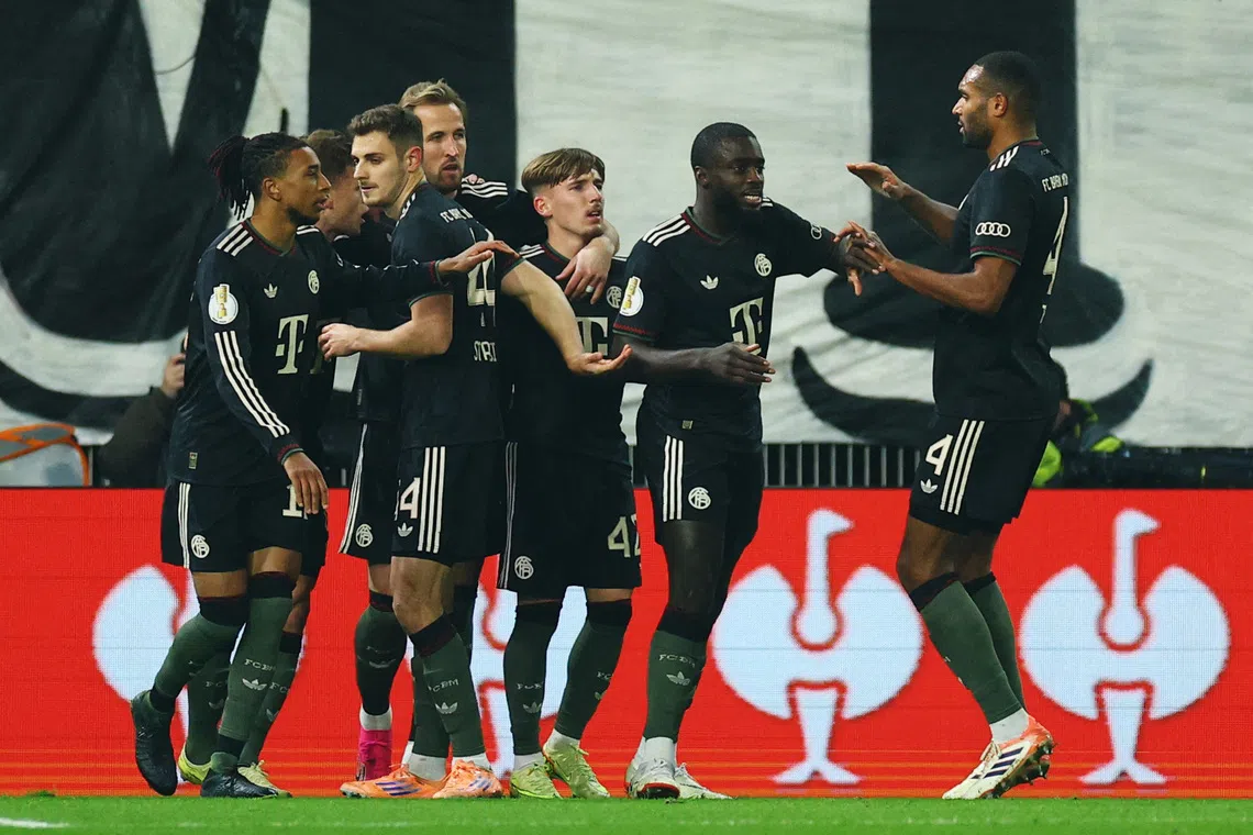 Soccer Football - DFB Cup - Round of 16 - 1. FC Union Berlin v Bayern Munich - Stadion An der Alten Forsterei, Berlin, Germany - December 3, 2025 Bayern Munich players celebrate their first goal, an own goal scored by 1. FC Union Berlin's Ilyas Ansah REUTERS/Lisi Niesner