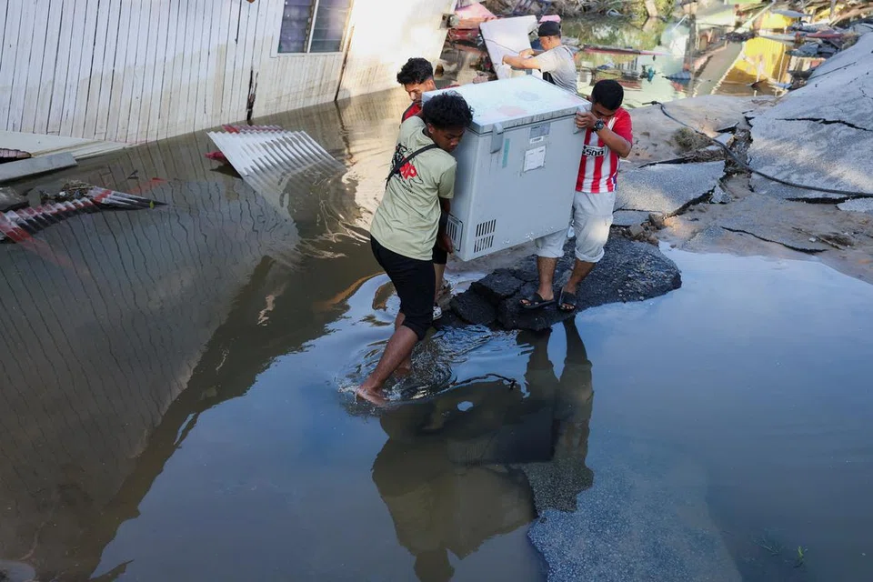 Malaysians return to devastated homes as flood waters recede; more rain ...