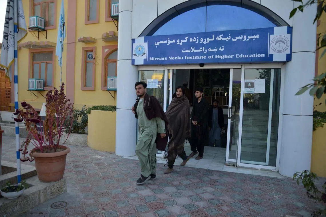 Male university students walk out of their university in Kandahar Province on December 21, 2022. - Afghanistan's Taliban rulers have banned university education for women nationwide, provoking condemnation from the United States and the United Nations over another assault on human rights. (Photo by STRINGER / AFP)